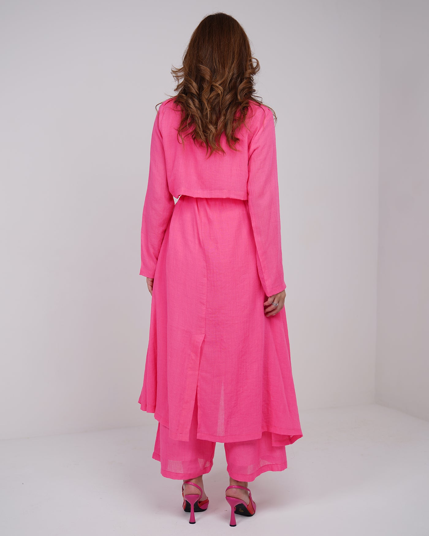 Hot pink long line trench coat with wide leg trousers