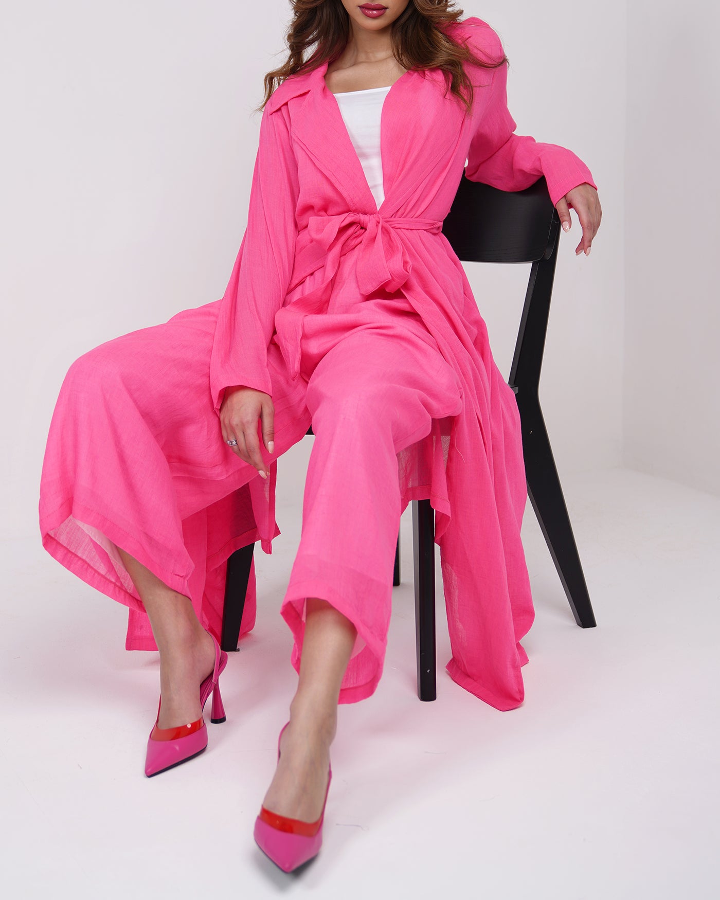 Hot pink long line trench coat with wide leg trousers