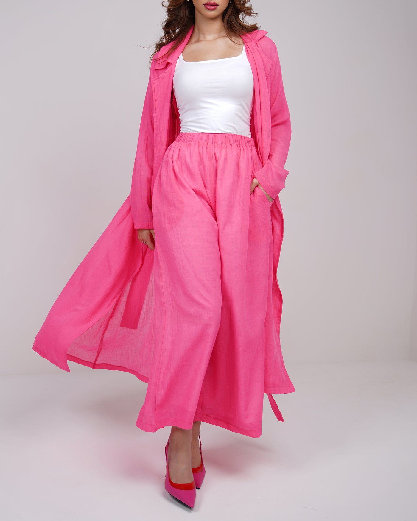 Hot pink long line trench coat with wide leg trousers