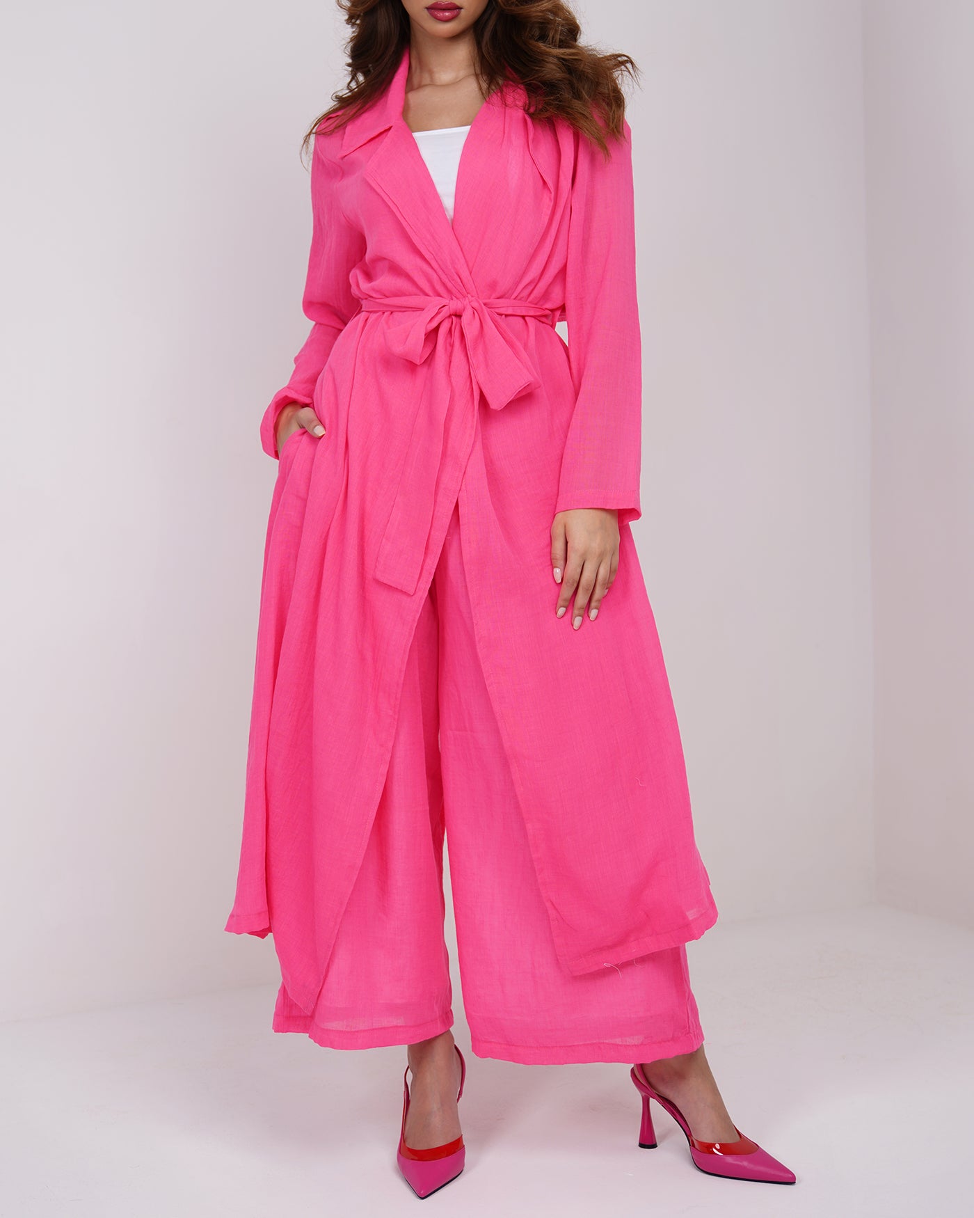 Hot pink long line trench coat with wide leg trousers